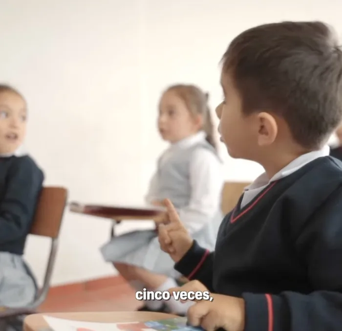 El aula: la profesora explica la regla de las cinco veces